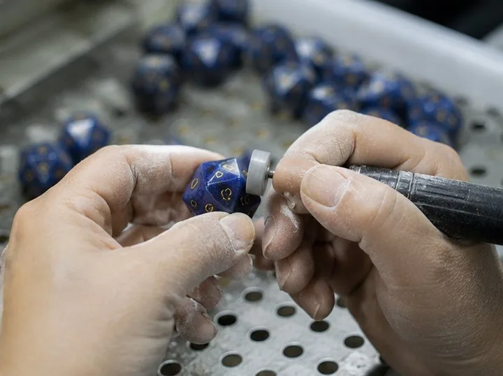 CuiShen craftsperson hand-finishing a gemstone D20